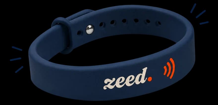 The ZEED band: navy silicone with the cream wordmark and the moulded contactless mark